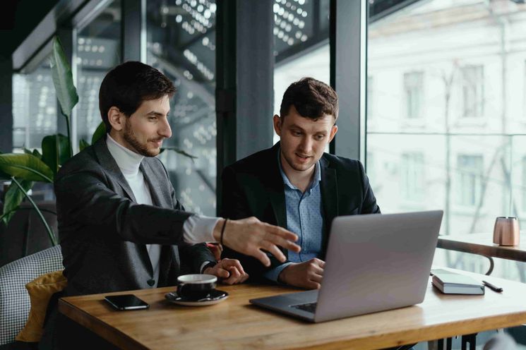 two businessmen checking crm software forecasts 